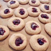 jam-filled hazelnut cookies on parchment