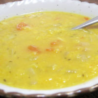 bowl of split mung bean soup with a spoon