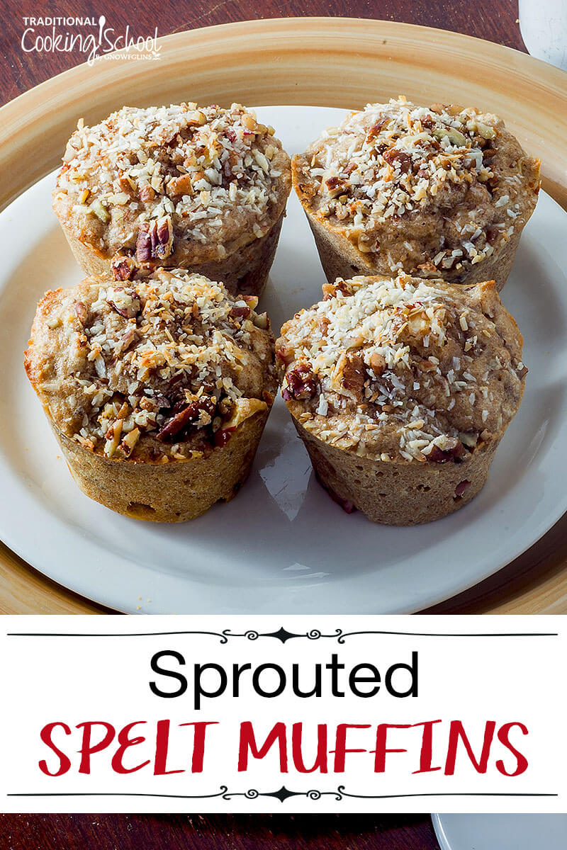 four spelt muffins on white plate