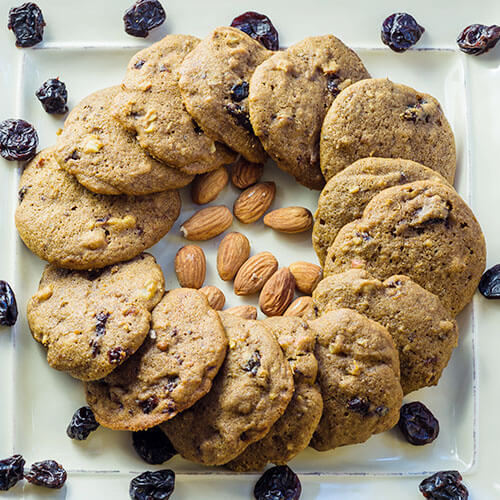 Fruit and nut Christmas cookies with almonds and raisins close up