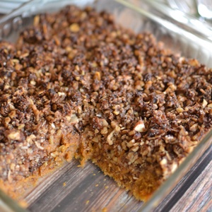 Sweet potato casserole with crumble topping in a glass casserole dish.