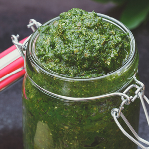 Garlic Scape Pesto | Scapes are the tall stems and unopened flower buds of certain hard-neck varieties of garlic, which should be snipped before the flowerheads mature. Then of course, eat the scapes! My favorite way is this pesto, which accompanies pasta, chicken, salmon, potato salad, and burgers beautifully. | TraditionalCookingSchool.com