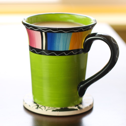 Colorful cup filled with coffee