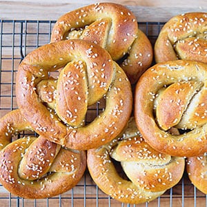stack of braided sourdough pretzels sprinkled with sesame seeds