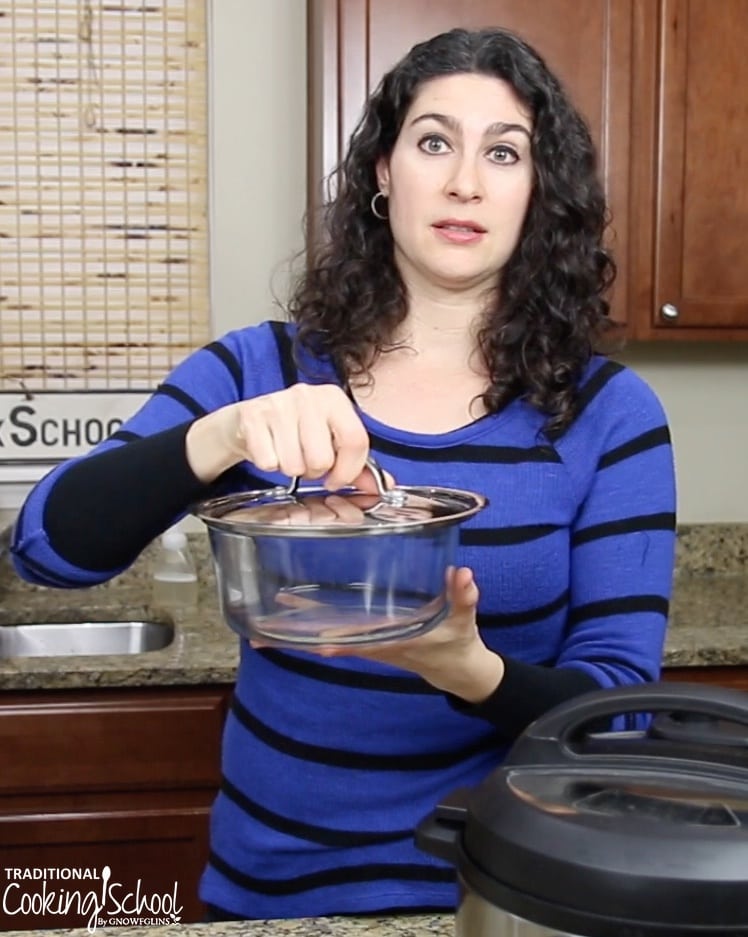 dark-haired woman holding instant pot accessories