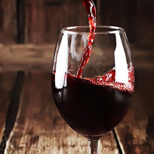 red wine being poured into wine glass