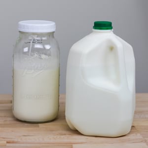 half gallon of cream next to gallon of milk