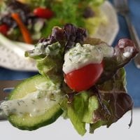 cucumber ranch dressing on a fork with lettuce tomato and cucumber