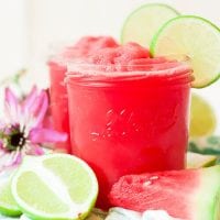 bright pink watermelon lime cooler with lime slice and text overlay