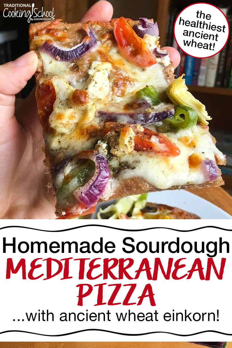hand holding up a piece of mediterranean sourdough pizza topped with cheeses, tomatoes, bell peppers, onions, and artichoke hearts with text overlay: "Homemade Sourdough Mediterranean Pizza...with ancient wheat einkorn!"