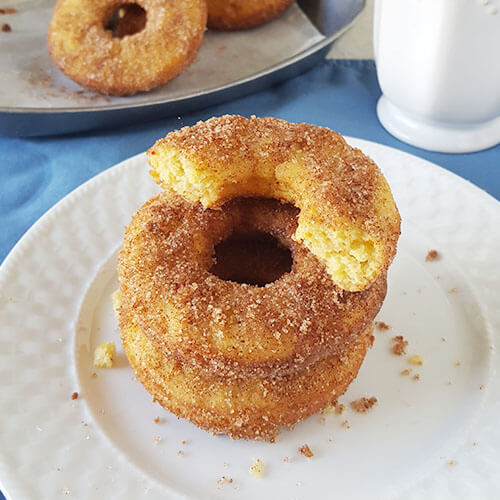 stack of baked donuts on a plate with crispy sugary topping