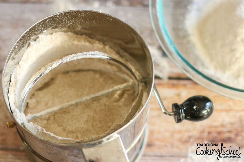sifter full of whole grain flour being turned into homemade all-purpose flour