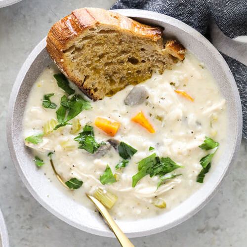 bowl of chowder made in the Instant Pot with a thick slice of bread dipped in the bowl