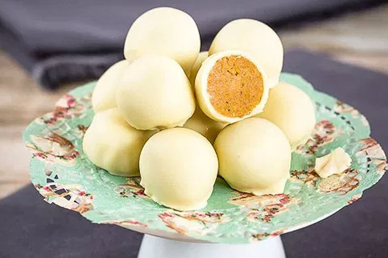 pumpkin white chocolate desserts stacked on serving tray on gray napkin