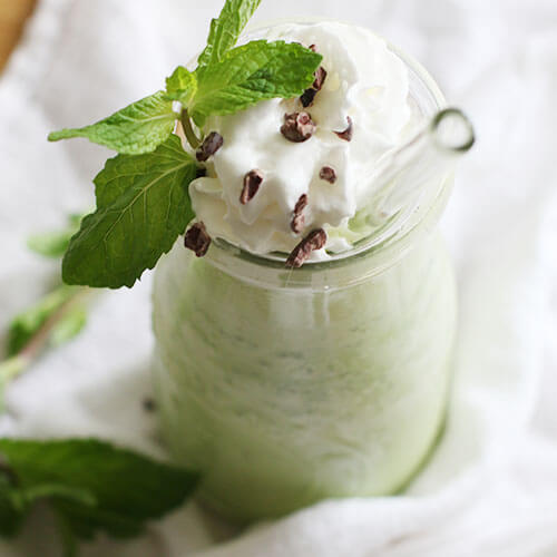 keto shamrock shake garnished with mint, cacao nibs, and whipped cream