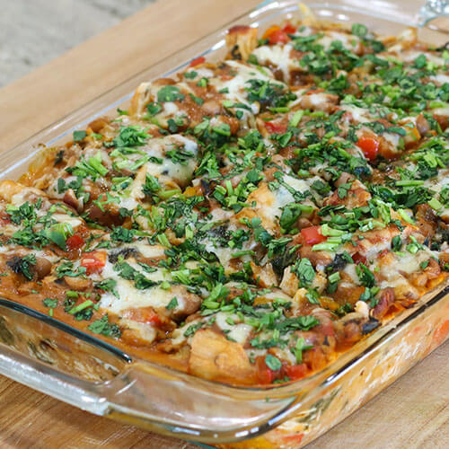 casserole dish of chicken enchiladas with text overlay: "Easy Real Food Chicken Enchiladas (healthy Mexican casserole!)"