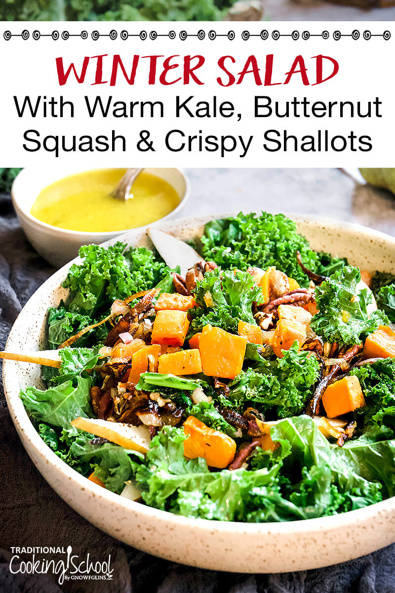 beautiful warm kale salad, topped with winter veggies and a lemon dressing, with text overlay: "Winter Salad With Warm Kale, Butternut Squash & Crispy Shallots"