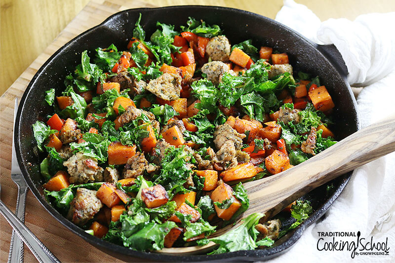 cast iron skillet of sweet potato, ground meat, and kale stirfry -- a recipe cooked in 30 minutes or less!