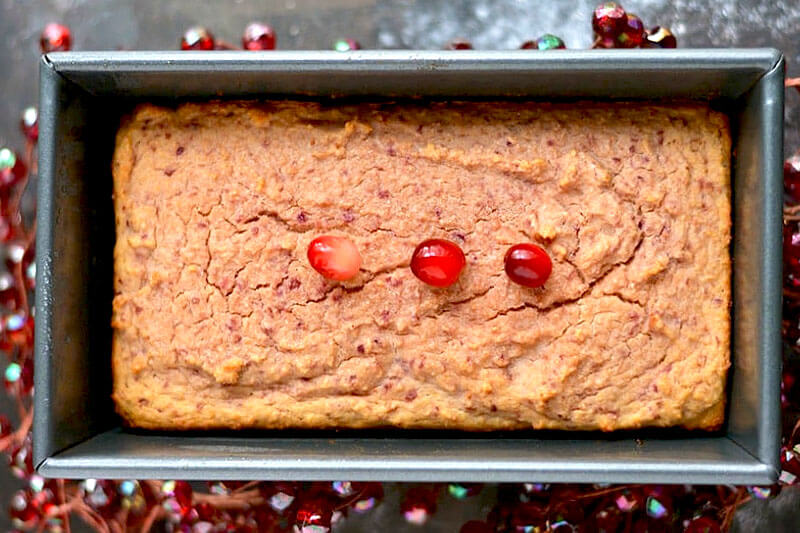overhead shot of a large loaf pan of cranberry coconut bread