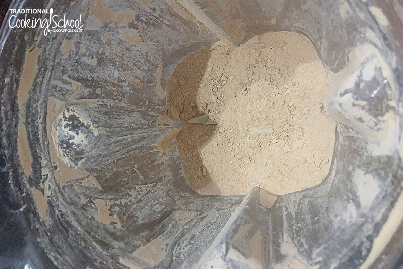 overhead photo of a Vitamix container full of finely powdered, beige-colored sugar