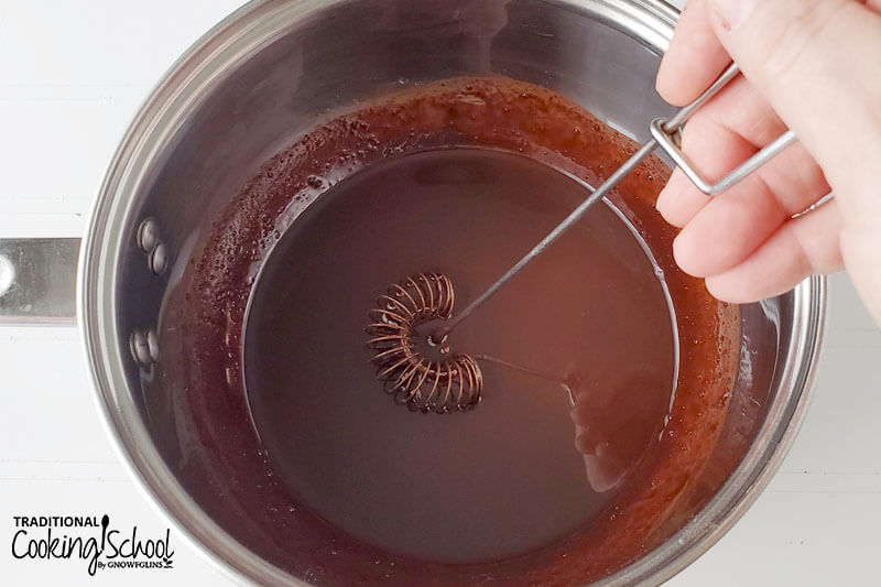 whisking sugar-free chocolate mixture together in a large stainless steel pot