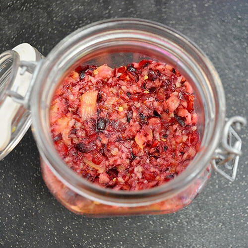 overhead shot of a glass jar of fermented cranberry relish