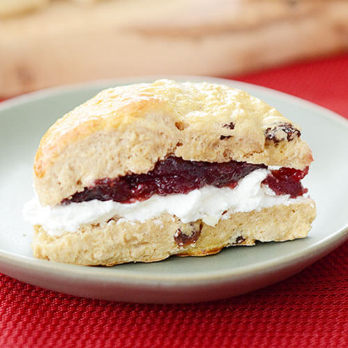 fluffy scone wedge, spread with cream and jam in the middle