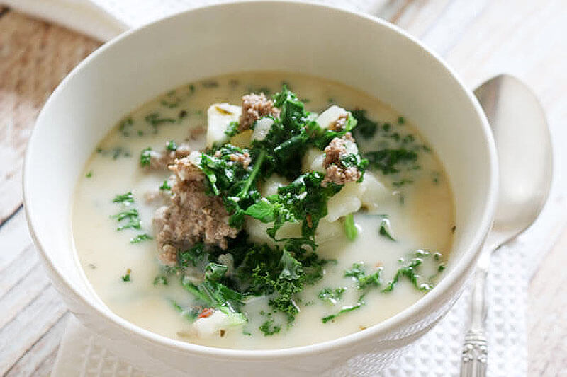 beef and kale Instant Pot soup in a white ceramic bowl