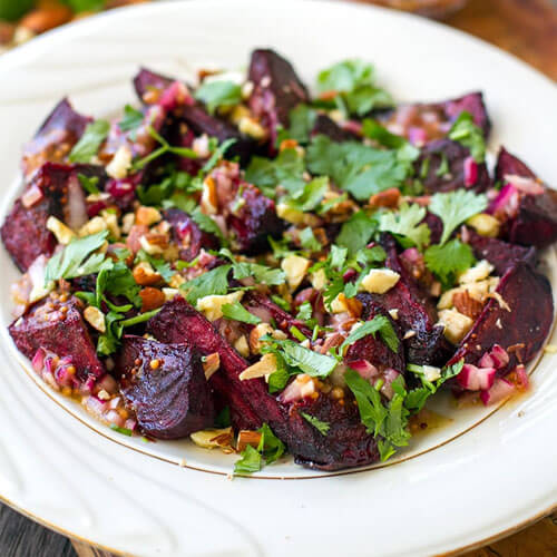 colorful beet salad sprinkled with fresh herbs
