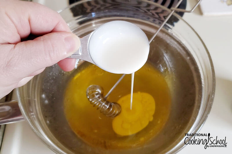 adding cream to cocoa butter in a double boiler