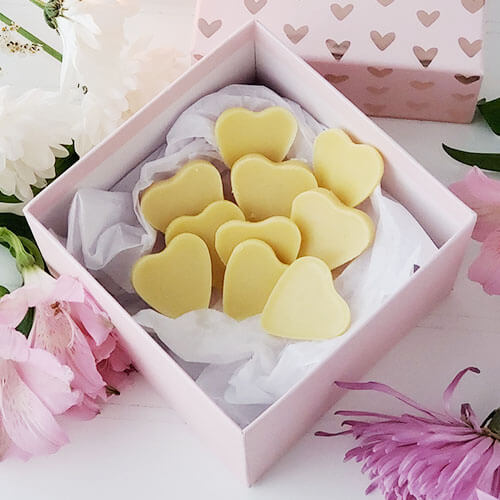 pink decorative box of cream-colored, heart-shaped homemade candy