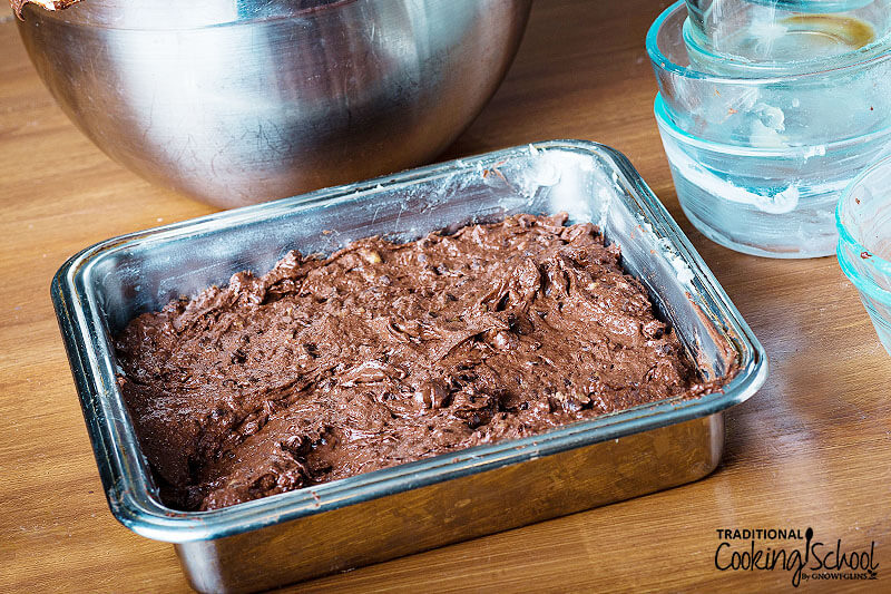 Gluten free brownie batter in a square pan.