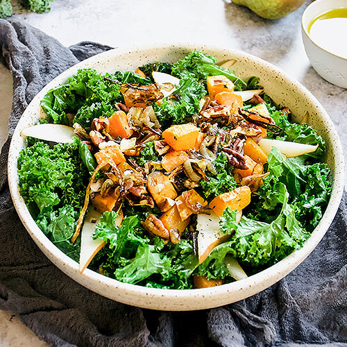 large green salad with kale, sweet potatoes, pears, and nuts
