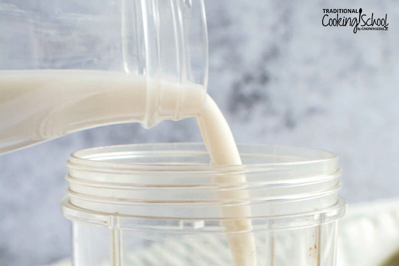 pouring milk into a blender container