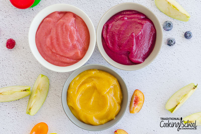 three bowls of colorful fruit purees