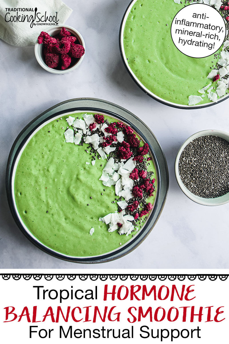 bright green smoothie bowl garnished with coconut, freeze-dried raspberries, and chia seeds. Text overlay says: "Tropical Hormone Balancing Smoothie For Menstrual Support (anti-inflammatory, mineral-rich, hydrating!)"