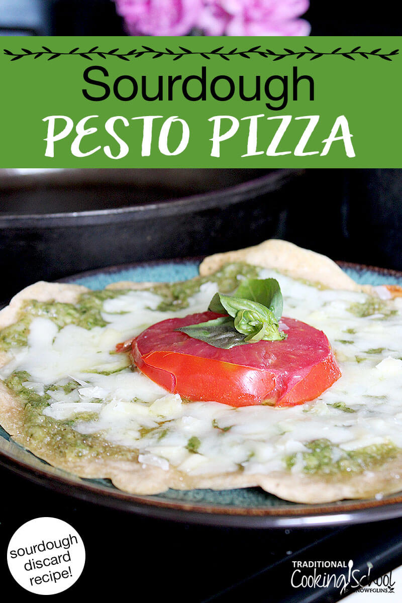 cheesy, herbed pizza on a plate. Text overlay says: "Sourdough Pesto Pizza (sourdough discard recipe!)"