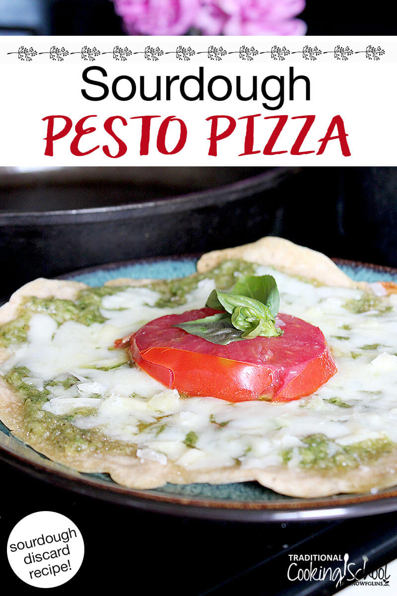 cheesy, herbed pizza on a plate. Text overlay says: "Sourdough Pesto Pizza (sourdough discard recipe!)"