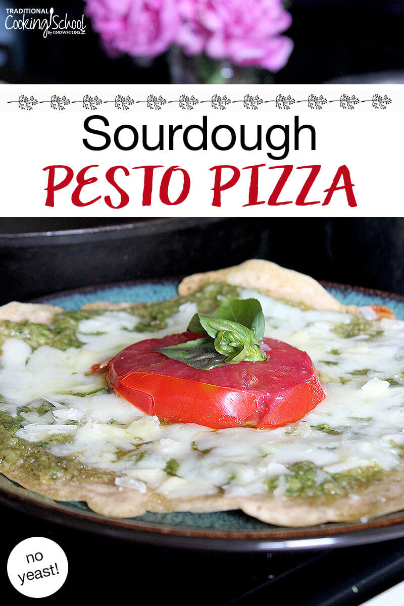 cheesy, herbed pizza on a plate. Text overlay says: "Sourdough Pesto Pizza (no yeast!)"