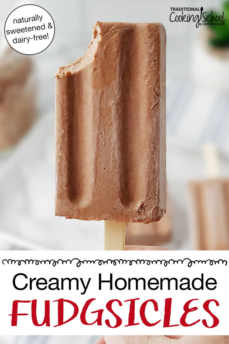 hand holding up a chocolate popsicle with a bite taken out of it. Text overlay says: "Creamy Homemade Fudgesicles (naturally sweetened and dairy-free!)"