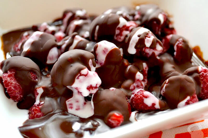 homemade chocolate magic shell drizzled over fresh berries
