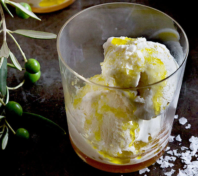 glass bowl of vanilla ice cream drizzled with olive oil