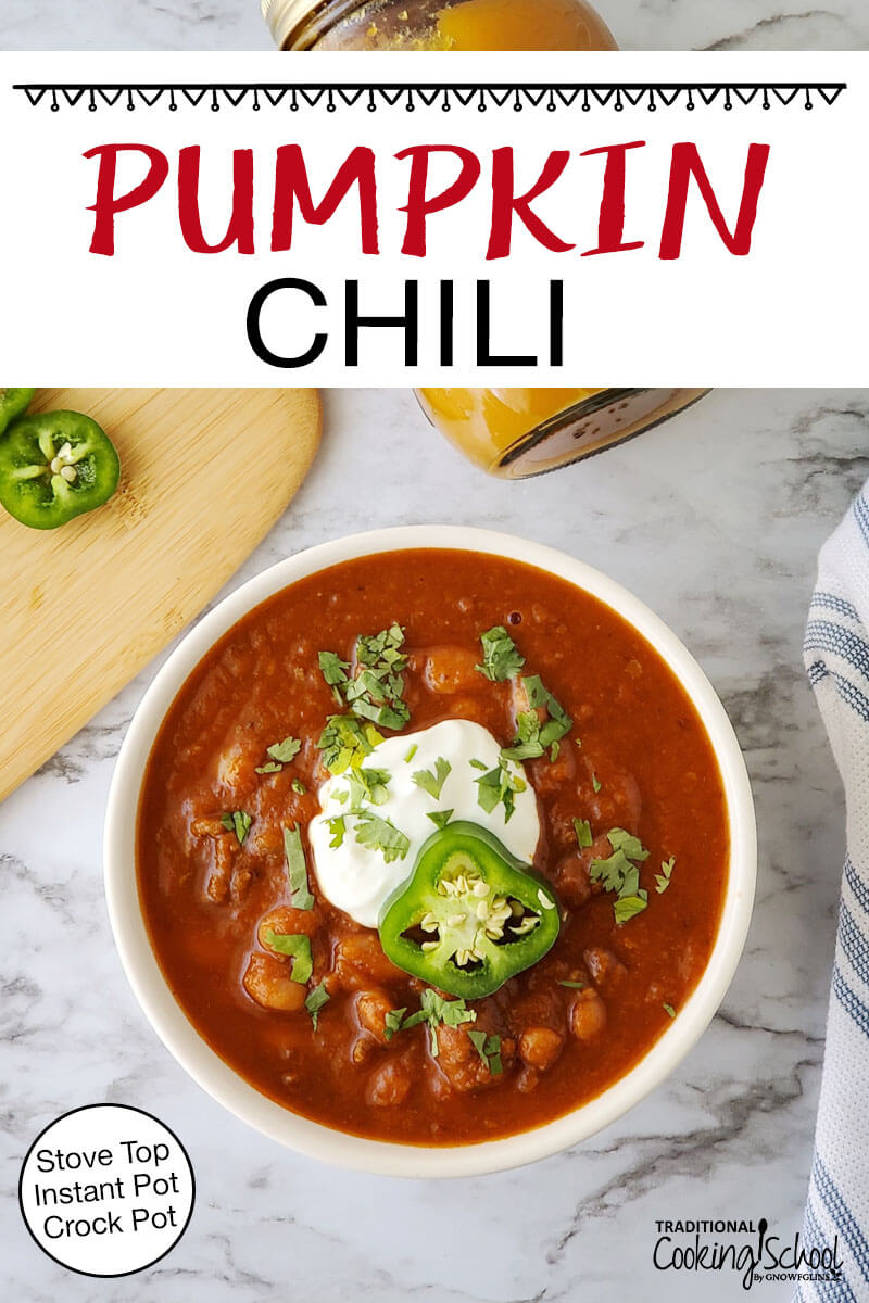 A bowl of chili garnished with fresh herbs, sour cream, and a slice of pepper. Text overlay says: "Pumpkin Chili (Stove Top, Instant Pot, Crock Pot)"