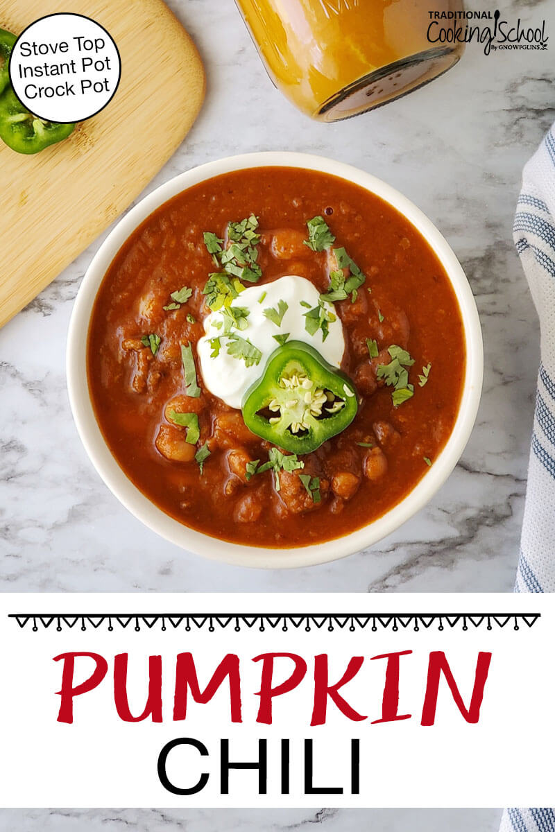 A bowl of chili garnished with fresh herbs, sour cream, and a slice of pepper. Text overlay says: "Instant Pot Pumpkin Chili (Stove Top, Instant Pot, Crock Pot)"