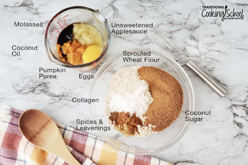 Wet and dry ingredients in separate bowls for making cookies, including: molasses, coconut oil, pumpkin puree, eggs, collagen, spices and leavenings, coconut sugar, sprouted wheat flour, and unsweetened applesauce.