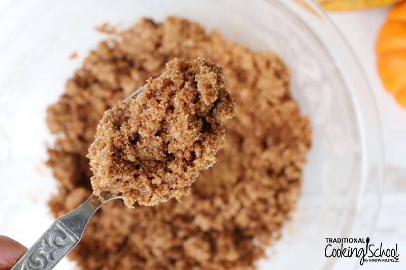 Close-up shot of a spoonful of crumb topping for coffee cake.