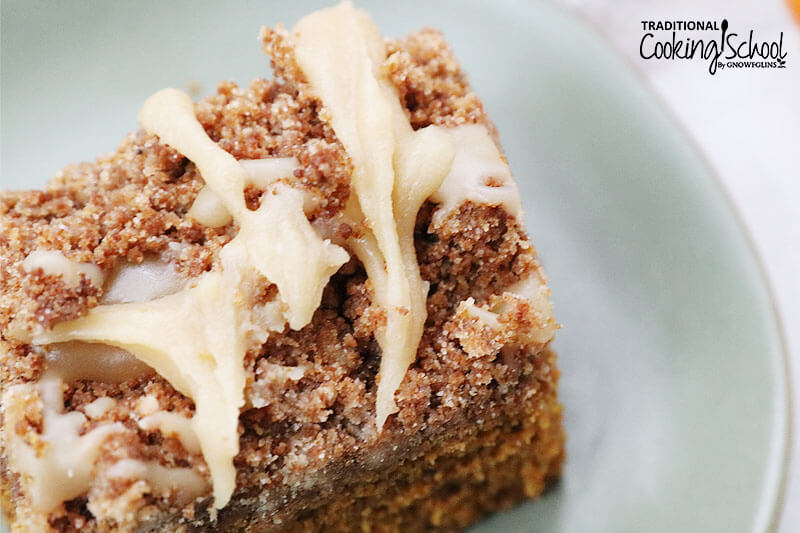 Close-up shot of the streusel topping and vanilla icing on a slice of coffee cake.