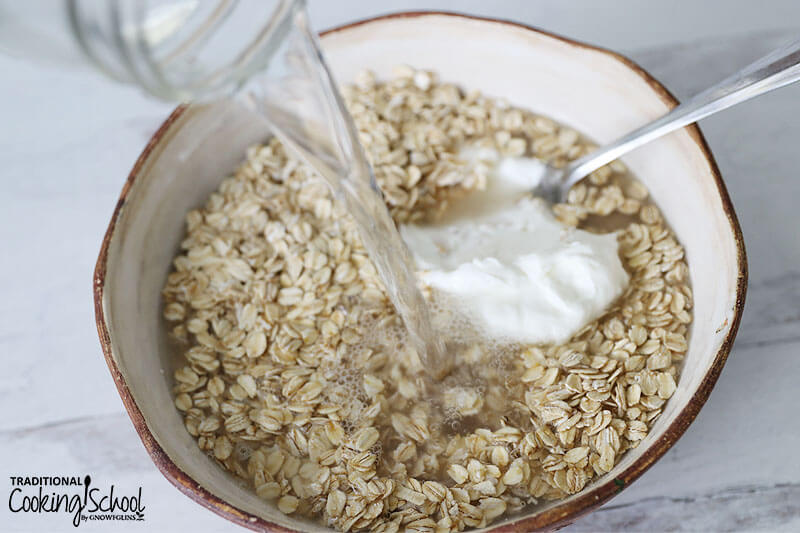 Water being poured into a large bowl of rolled oats and yogurt.