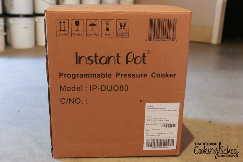 Unopened cardboard box labeled: "Instant Pot Programmable Pressure Cooker Model: IP-DUO80"