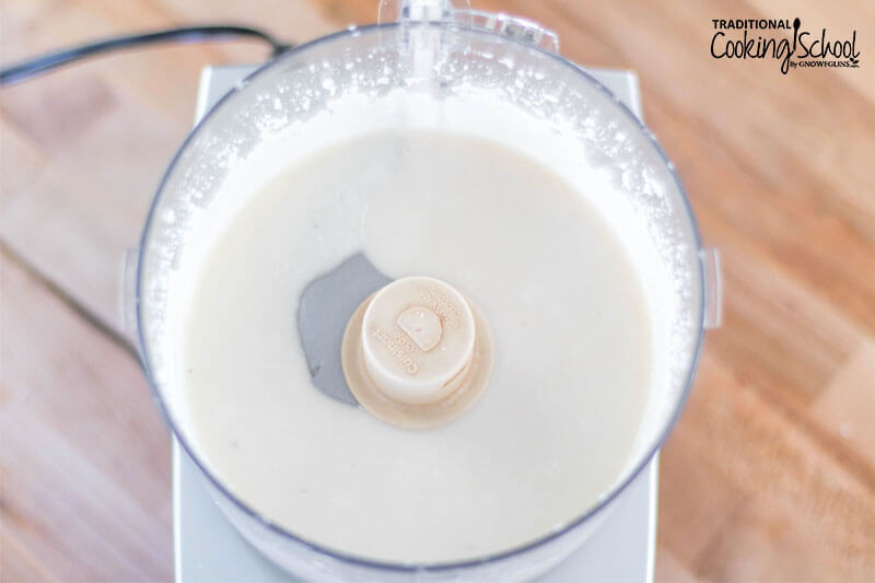 Coconut butter in a food processor: a thick, smooth liquid.